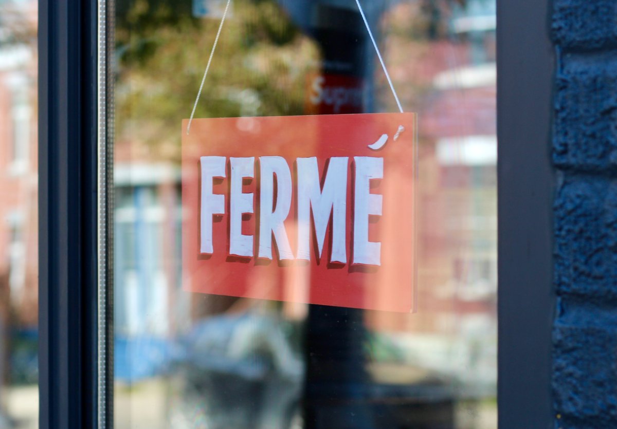 A closed sign hangs in the entrance of a clothing store in Montreal's Plateau-Mont-Royal borough.