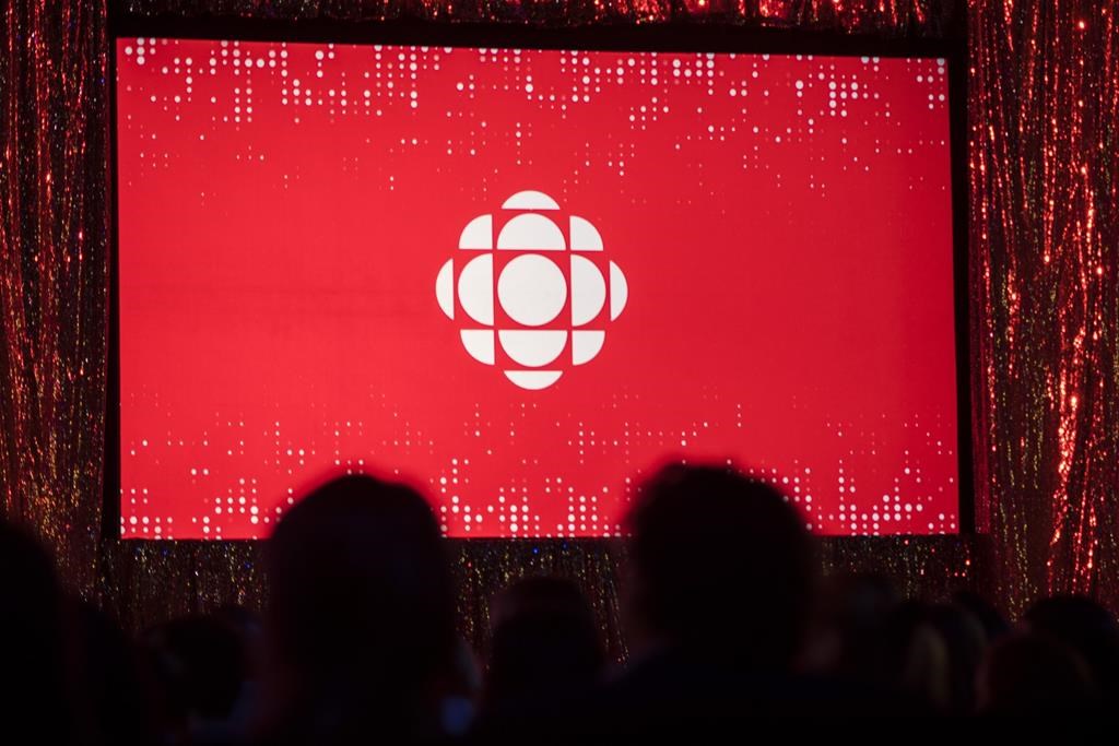 The CBC logo is projected onto a screen in Toronto on May 29, 2019. The CBC says it's accelerating efforts to meet diverse hiring, retention and promotion goals after its Yukon Morning radio show host lambasted the broadcaster for its failings live on-air. The public broadcaster says that by 2021–22, it wants half of all new hires for executive and senior management positions to be Indigenous people, visible minorities, or people with disabilities. It also plans to double retention and promotion rates for people from these three groups. THE CANADIAN PRESS/Tijana Martin.