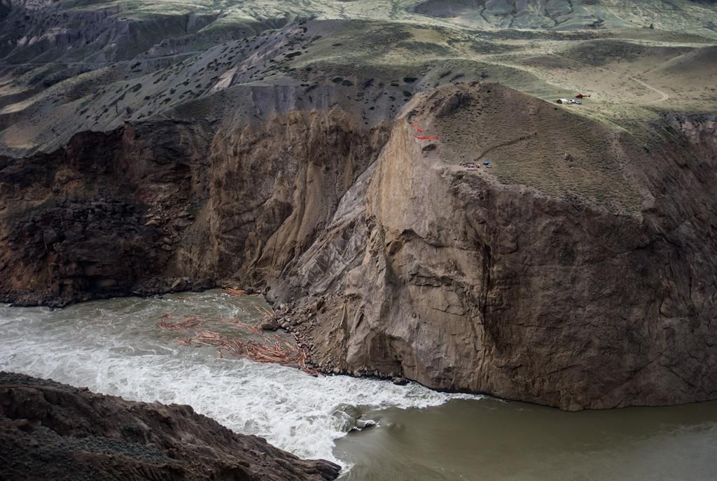 Workers are seen on the cliff at the site of a massive rock slide on the Fraser River near Big Bar, west of Clinton, B.C., on Wednesday July 24, 2019.