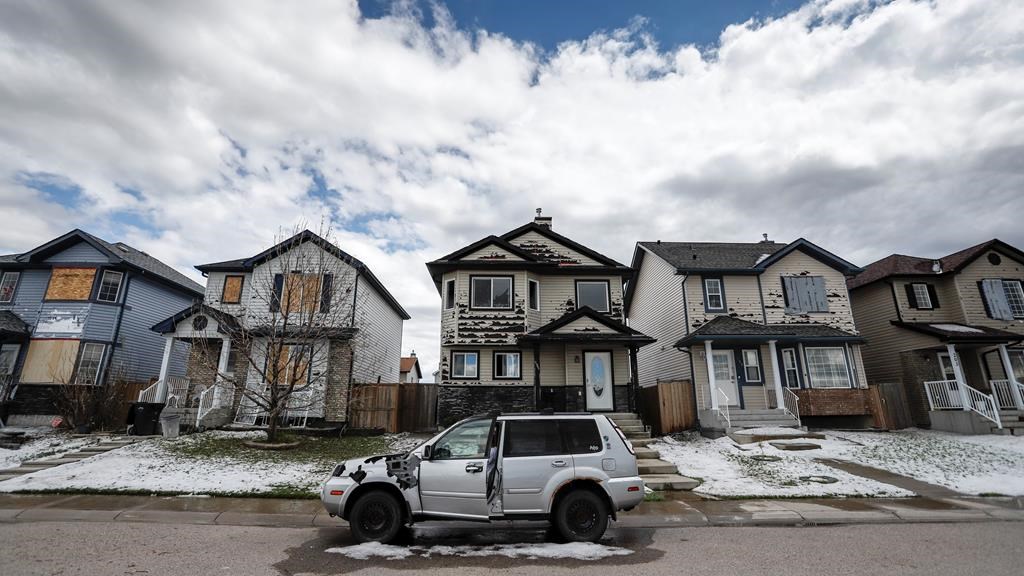 Residents survey the damage before begining cleanup in Calgary, Alta., Sunday, June 14, 2020, after a major hail storm damaged homes and flooded streets on Saturday.THE CANADIAN PRESS/Jeff McIntosh