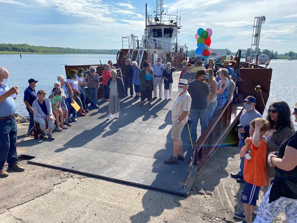 Residents celebrate the reopening of the river ferry in Gagetown, N.B., on Sunday, June 28, 2020.