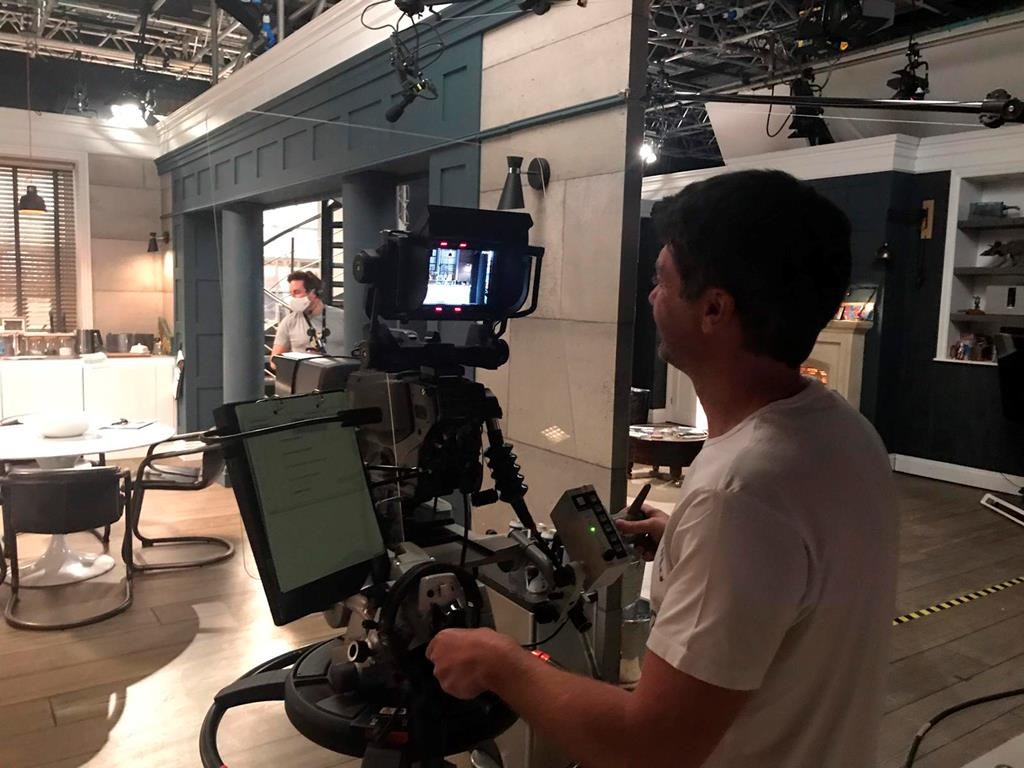 In this photo made available Wednesday June 10, 2020 by ITV/Emmerdale, reduced production staff film a scene on the set of the television show 'Emmerdale' in Leeds, England.