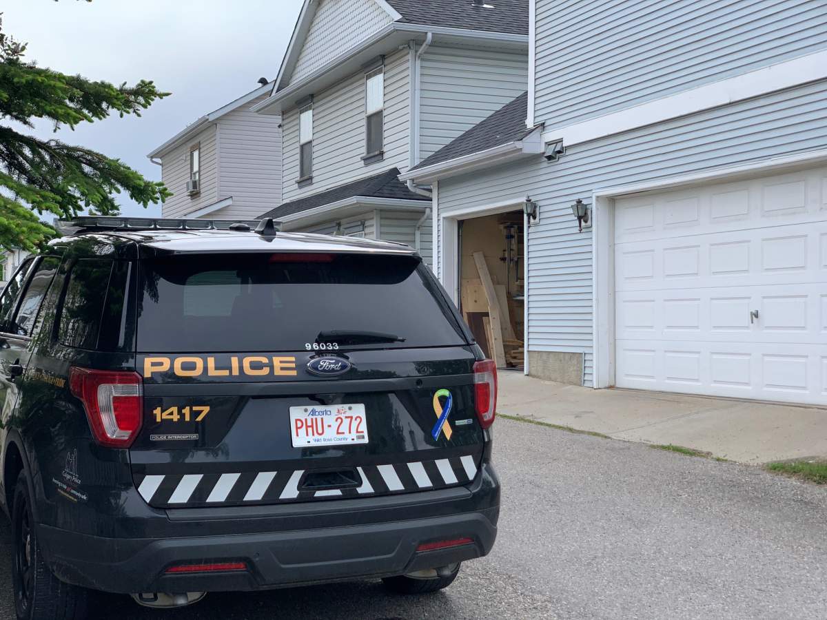 Calgary police officers at a home in McKenzie Towne in relation to the investigation into a missing man believed to be killed.