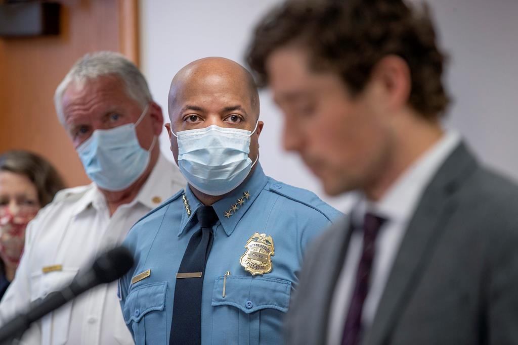 FILE - In this May 28, 2020, file photo, Minneapolis Police Chief Medaria Arradondo, center, listens as Minneapolis Mayor Jacob Frey becomes emotional during a news conference in Minneapolis, Minn. George Floyd‚Äôs death and the protests it ignited nationwide over racial injustice and police brutality have raised questions about whether Arradondo ‚Äî or any chief ‚Äî can fix a department that's now facing a civil rights investigation. (Elizabeth Flores/Star Tribune via AP, File).
