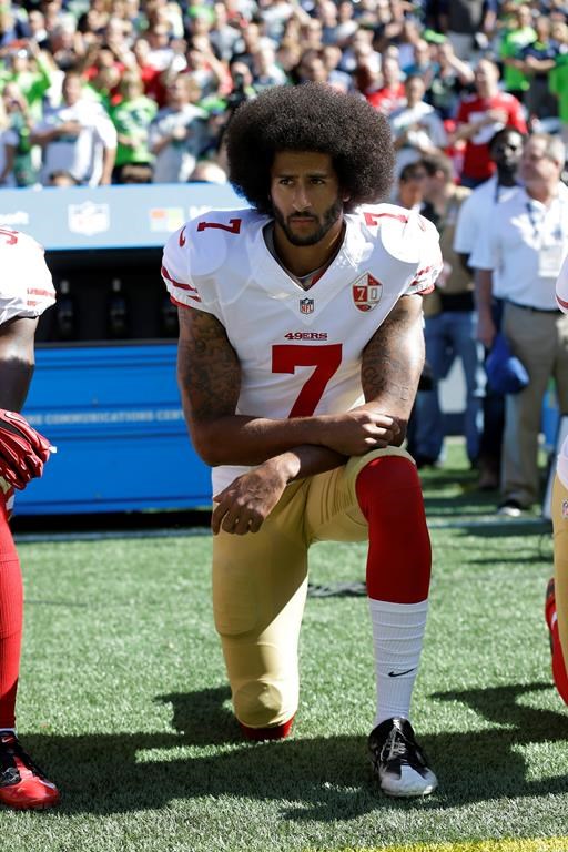 FILE - In this Sept. 25, 2016, file photo, San Francisco 49ers' Colin Kaepernick kneels during the national anthem before an NFL football game against the Seattle Seahawks, Sunday, Sept. 25, 2016, in Seattle. When Colin Kaepernick took a knee during the national anthem to take a stand against police brutality, racial injustice and social inequality, he was vilified by people who considered it an offense against the country, the flag and the military. Nearly four years later, it seems more people are starting to side with Kaepernick’s peaceful protest and now are calling out those who don’t understand the intent behind his action. (.