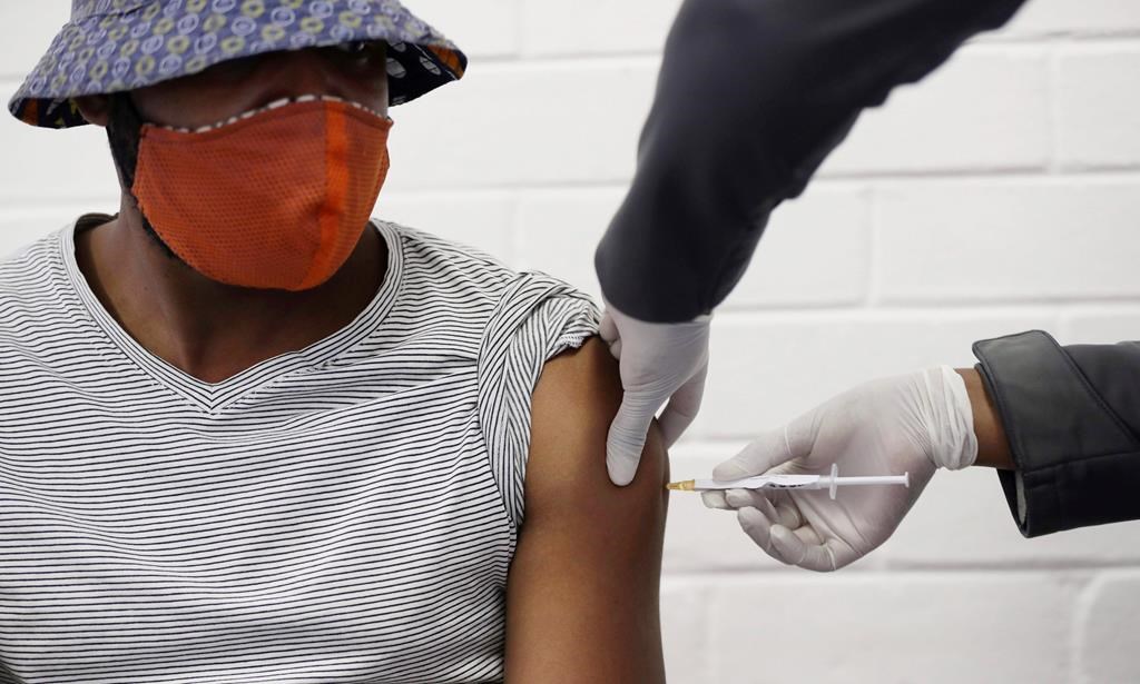 FILE - In this Wednesday, June 24, 2020 file photo, a volunteer receives a COVID-19 test vaccine injection. (AP Photo/Siphiwe Sibeko).