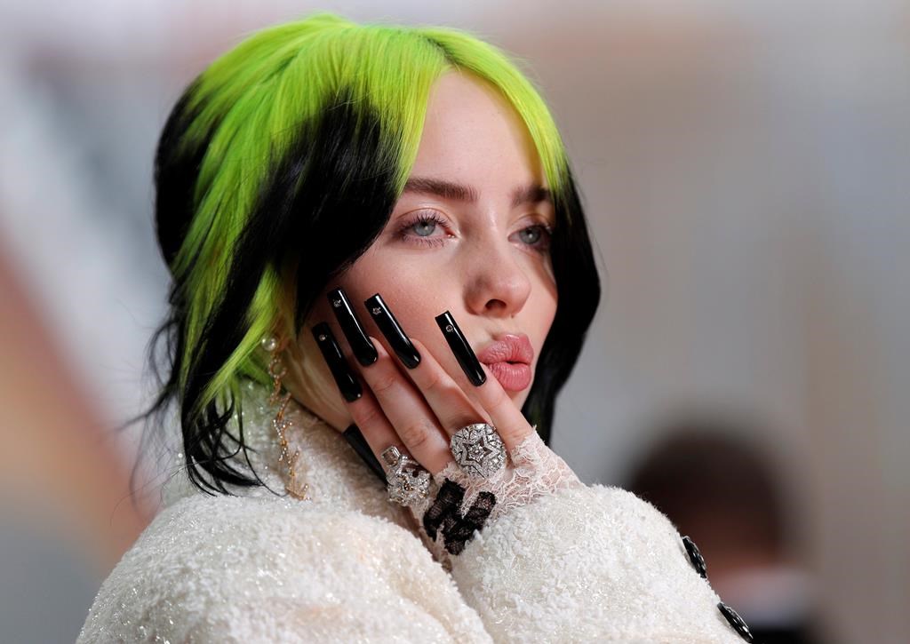FILE - In this Feb. 9, 2020 file photo, singer Billie Eilish arrives at the Oscars in Los Angeles. A judge has extended to three years a restraining order taken out by Eilish against a man who repeatedly appeared at her Los Angeles home. (AP Photo/John Locher, File).