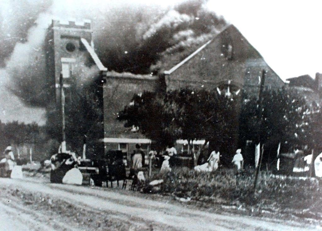FILE – In this 1921 file image, Mt. Zion Baptist Church burns after being torched by white mobs during the 1921 Tulsa massacre. (Greenwood Cultural Center via Tulsa World via AP)