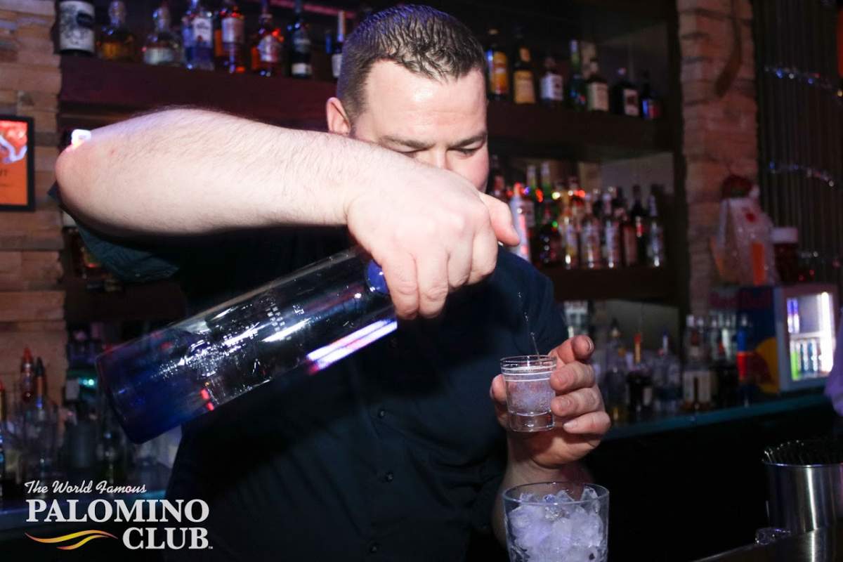 A bartender pours a drink at the Palomino Club during a recent New Year's celebration. The province won't allow patrons to dance or grab a drink up at the bar in the province's third phase of reopening.