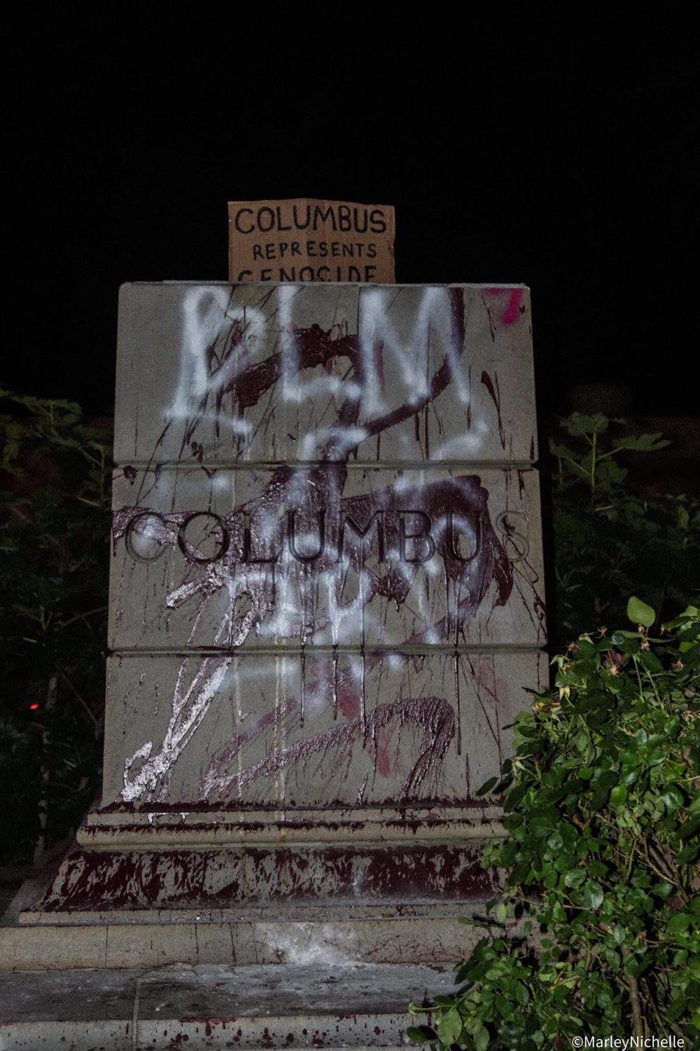 The defaced pedestal where a statue of Christopher Columbus once stood is seen at Byrd Park in Richmond, Va., Tuesday, June 9, 2020.