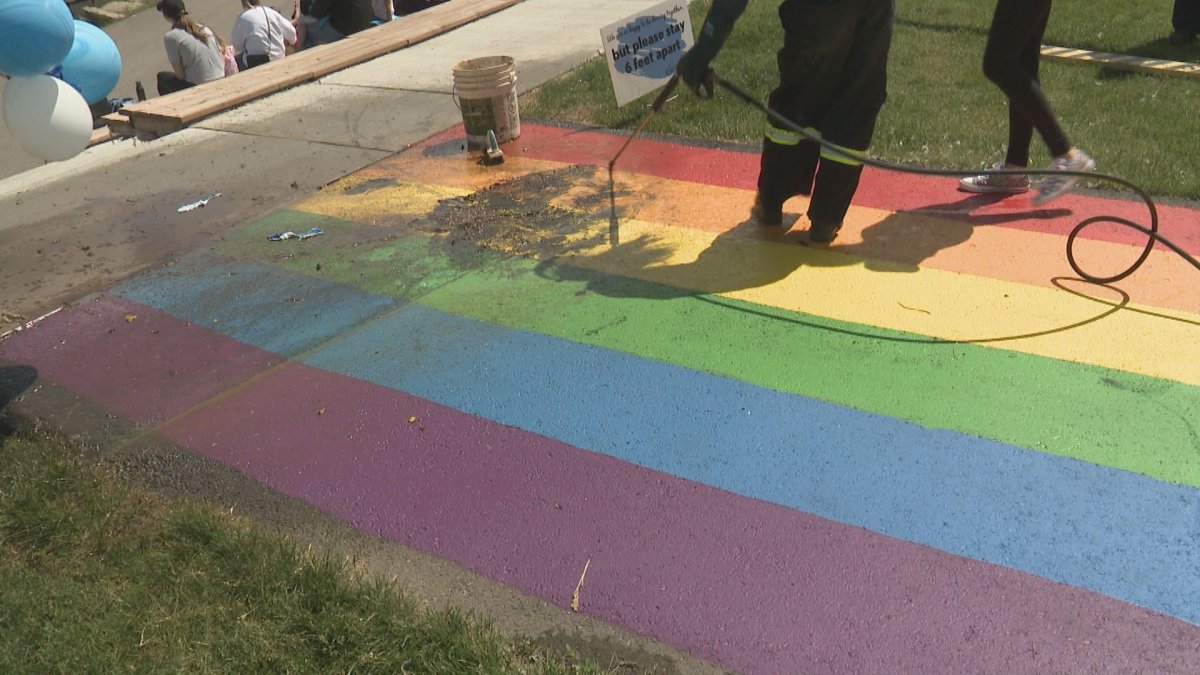 People in Airdrie are cleaning up a Pride sidewalk after vandals struck.