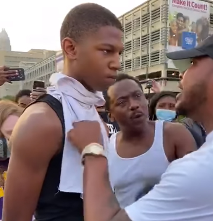 Curtis M. Hayes Jr., right, speaks to a 16-year-old while another man, 45, looks on during a protest march in Charlotte, N.C., on May 30, 2020.