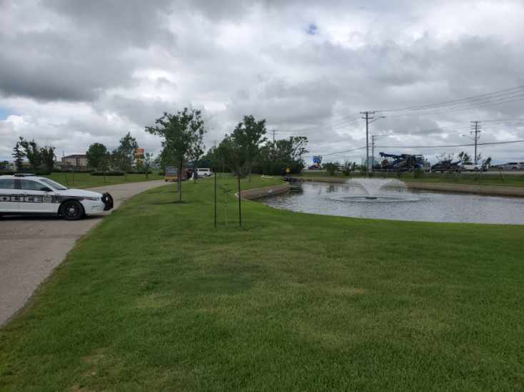 Police on scene after a car was found flipped on its roof at Chapel Lawn Funeral Home and Cemetery.