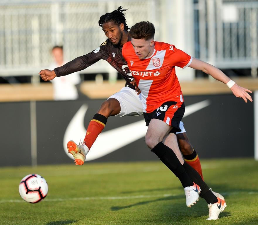 Ali Musse of Valour FC (left) and Joel Waterman of Cavalry FC vie for the ball during CPL action in Calgary, May 8, 2019. It looks like Prince Edward Island will lead the way in Canada's return to soccer, with the Canadian Premier League possibly looking to finally kick off its season in Charlottetown. 