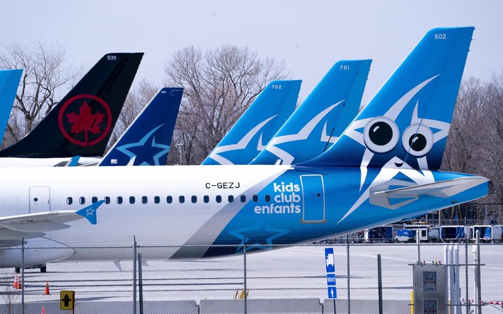 Air Transat and an Air Canada aircrafts are seen on the tarmac at Montreal-Trudeau International Airport in Montreal, on Wednesday, April 8, 2020. European Union regulators are suspending their investigation into Air Canada's proposed purchase of Transat AT pending the arrival of more data from the two Canadian travel companies.THE CANADIAN PRESS/Paul Chiasson.