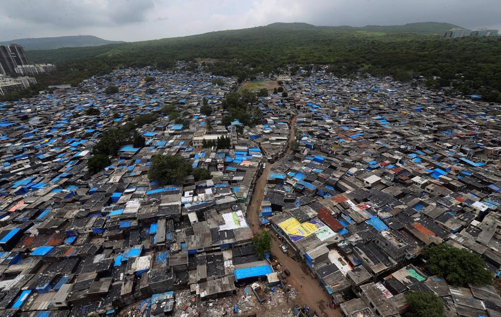 A general view of a slum area, some of which are containment zones, in Mumbai, India, Sunday, June 28, 2020. As of early August, 2020, India has the third highest number of COVID-19 cases after the U.S. and Brazil. (AP Photo/Rafiq Maqbool)