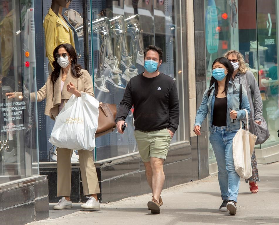 In this file photo, shoppers walk along Ste. Catherine Street in downtown Montreal.