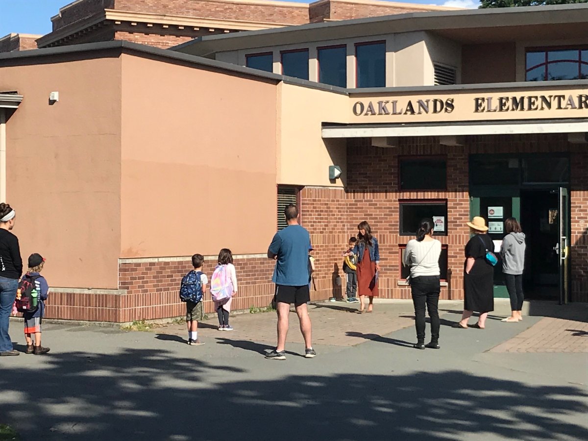 Students physically distance waiting to enter school on June 1, 2020 in Victoria, B.C.
