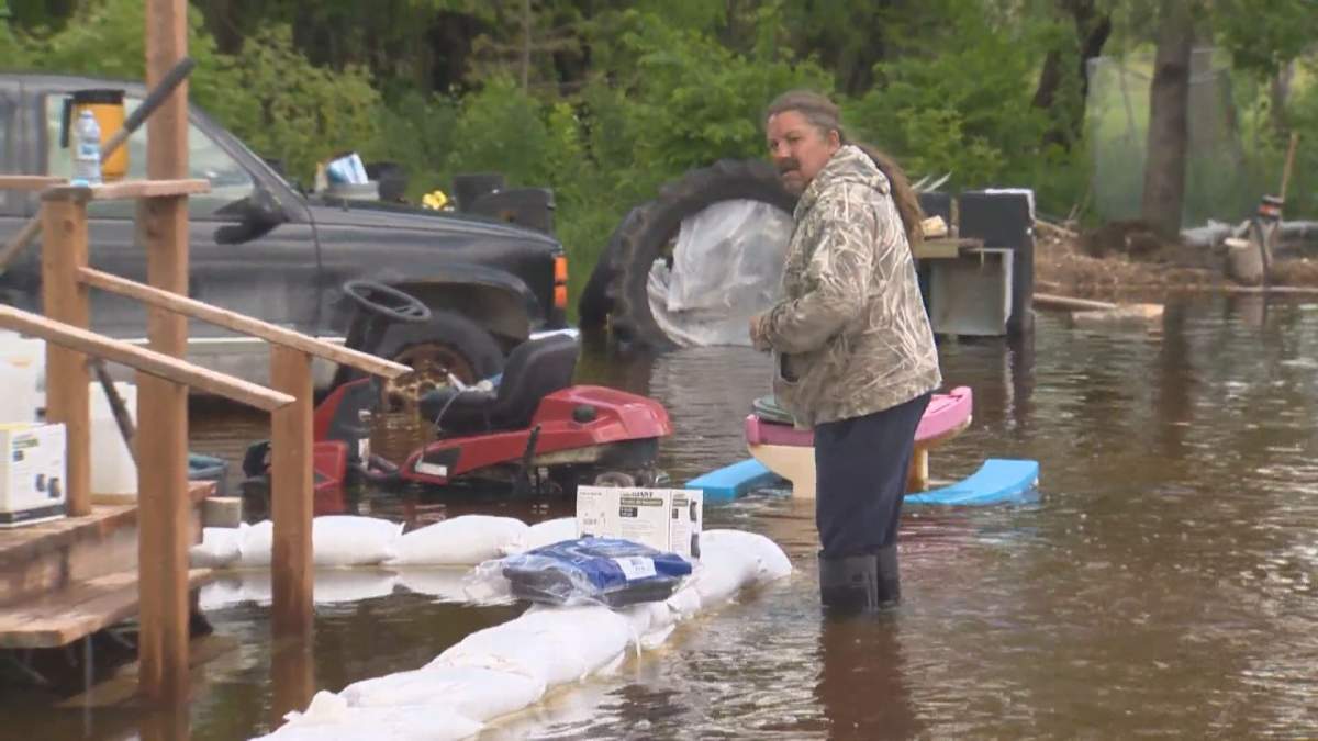 Marty Yatsko surveys his flooded yard in Sundown, Manitoba Wednesday afternoon.