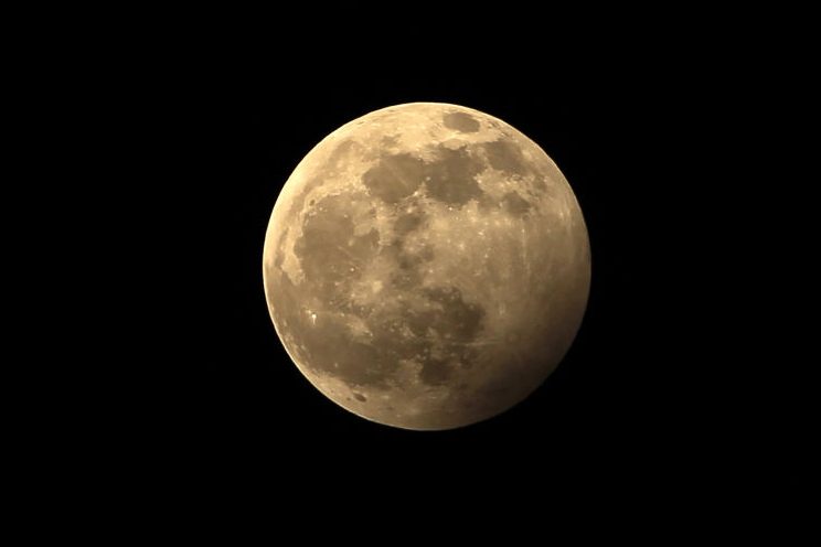 In this file photo, the full moon during a penumbral lunar eclipse is seen on the outskirts of Chandigarh on Jan. 11, 2020.
