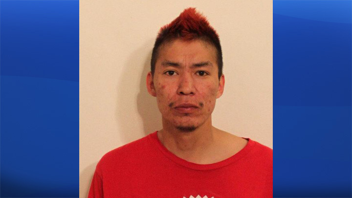 Calgary police say Tommie Boris Holloway is a suspect in the death of cafe owner Christopher Herblin. 