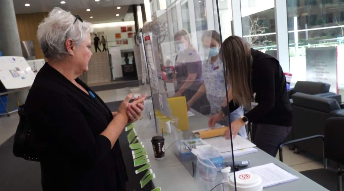 Staff checking in a guest at the Royal Alexandra Hospital in Edmonton, Alta. on Tuesday, June 16, 2020.