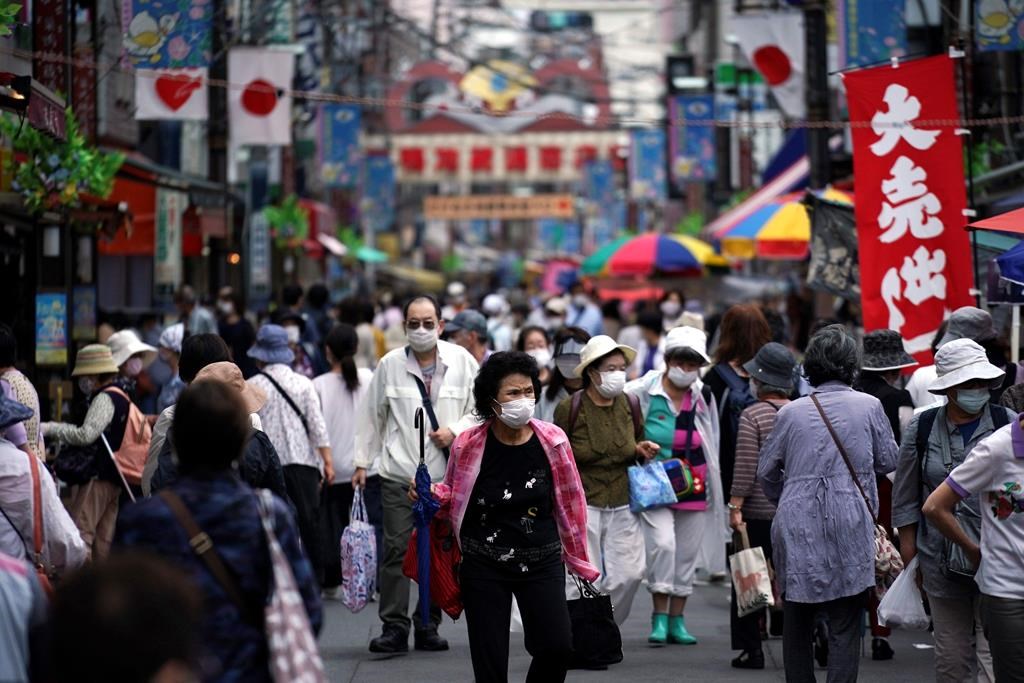 A street is crowded by shoppers in Tokyo Wednesday, June 24, 2020. Japan’s economy is opening cautiously, with social-distancing restrictions amid the coronavirus pandemic.