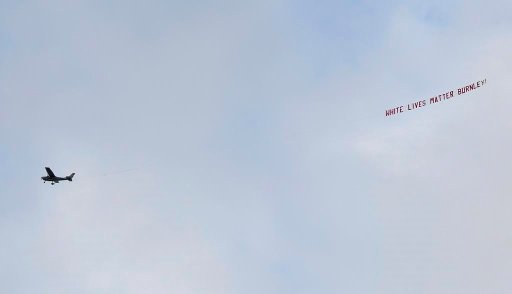 A plane towing a banner reading White Lives Matter Burnley flies above the stadium during the English Premier League soccer match between Manchester City and Burnley at Etihad Stadium, in Manchester, England, on June 22, 2020. (AP Photo/Michael Regan/Pool)