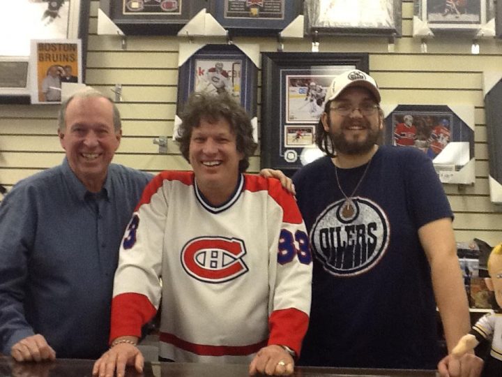 Alongside employee Reed Gilmore (right), Ross (left) and Wayne Arnott (centre) pose for a photo behind the Bluenose Collectible counter on March 31, 2012.