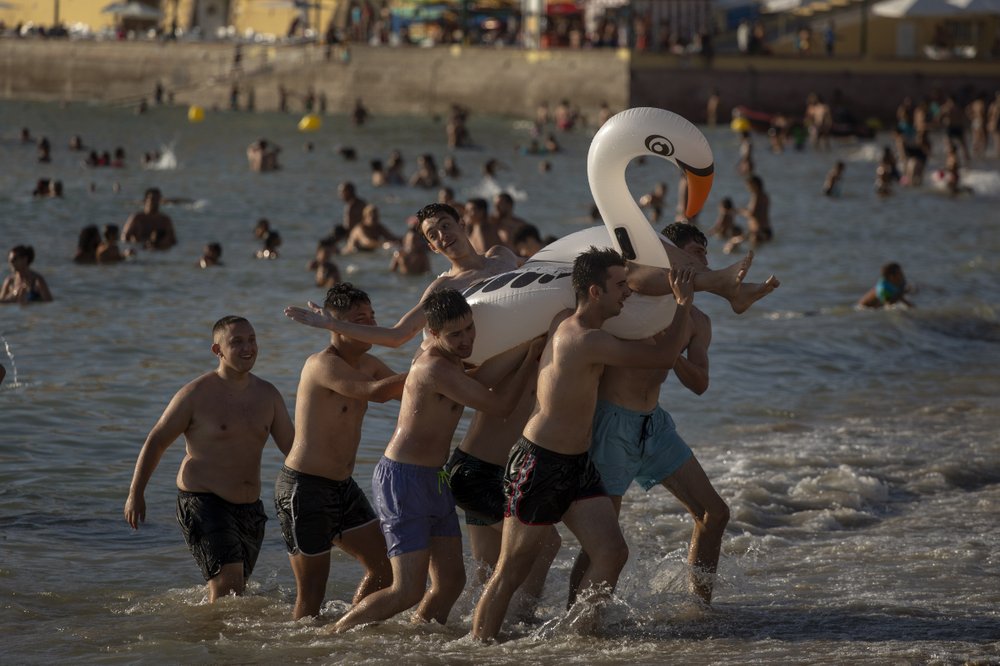 Bathers enjoy the beach in Cadiz, south of Spain, on Friday, July 24, 2020. With the coronavirus rebounding in parts of Spain, it appears that several regions have not adequately prepared to trace new infections in what was supposed to be an early detection system to prevent a new cascade of cases. 