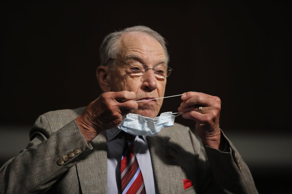 FILE - In this June 11, 2020, file photo, Sen. Chuck Grassley, R-Iowa, puts on a face mask during a Senate Judiciary Committee on Capitol Hill in Washington. Sen. Grassley will not be attending the Republican National Convention for the first time in his 40-year Senate career due to concerns about the coronavirus. 