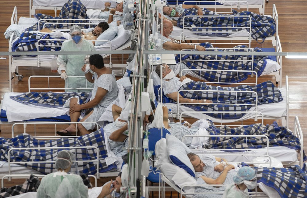 FILE - In this June 9, 2020, file photo COVID-19 patients lie on beds in a field hospital built inside a gym in Santo Andre, on the outskirts of Sao Paulo, Brazil.