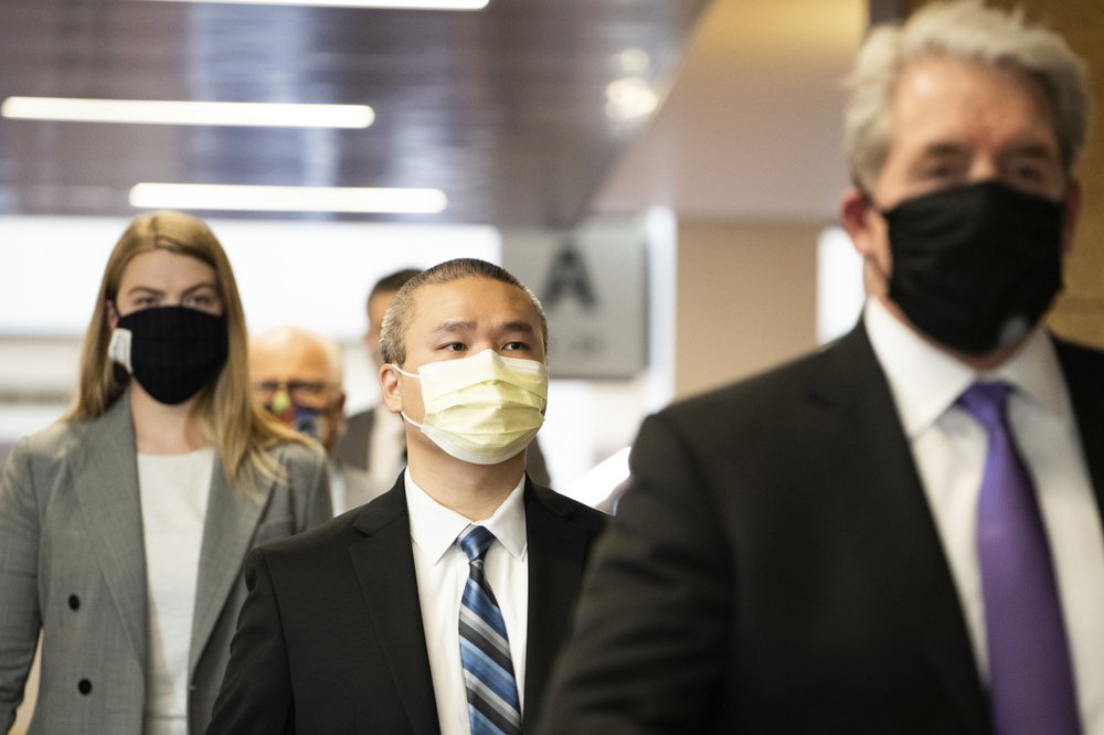 Former Minneapolis police officer Tou Thao is flanked by his attorneys as he arrives at the Hennepin County Courthouse before a motions hearing in Minneapolis on Tuesday, July 21, 2020. A Minnesota judge on Tuesday lifted a gag order in the criminal case against four former officers charged in death of George Floyd, but said he would take a news media coalition's request to make body camera footage more widely available under advisement. 