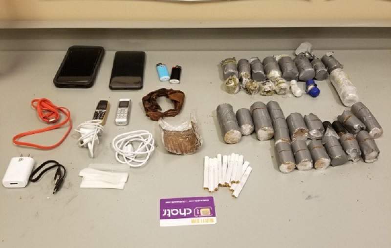 Kingston police say a Mississaugua man was caught trying to drop contraband over the walls of Collins Bay Institution.