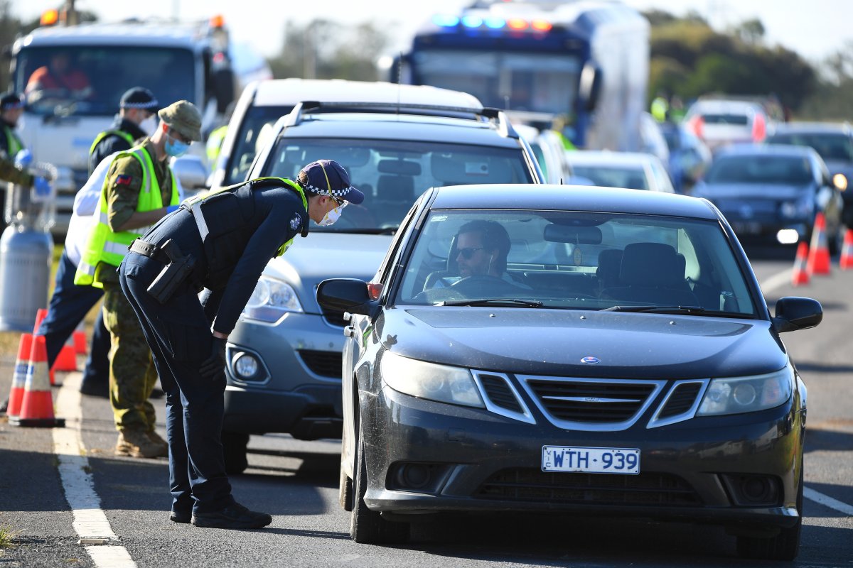 Victoria Police and ADF personnel work at a vehicle checkpoint along the Princes Freeway outside of Melbourne after the city went into lockdown in response to an outbreak of the coronavirus disease (COVID-19), near Melbourne, Australia, July 13, 2020. 
