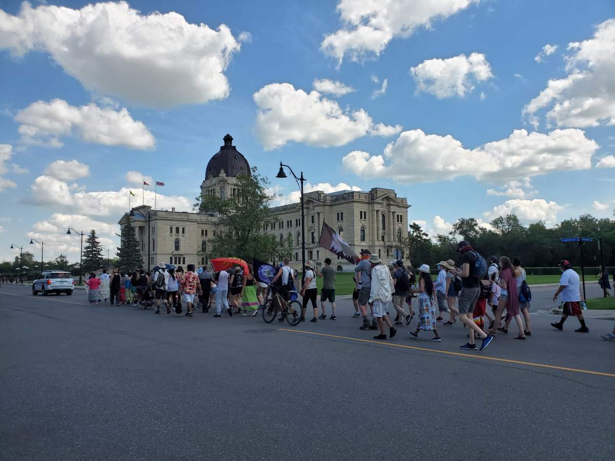 Dozens of supporters joined Tristen Durocher and Christ Merasty for the final leg of their walk from the Regina weigh scales to the legislative grounds.