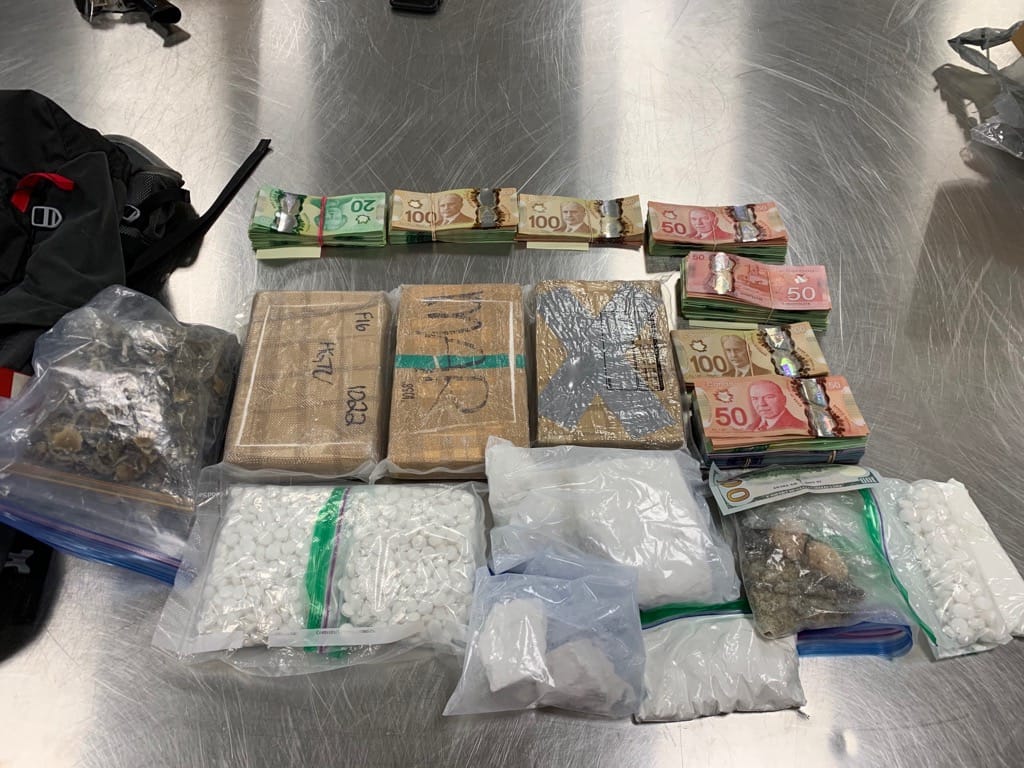Police display the items seized during the search of a residence in the 200 block of 13 Avenue Southeast on Tuesday, July 14, 2020.