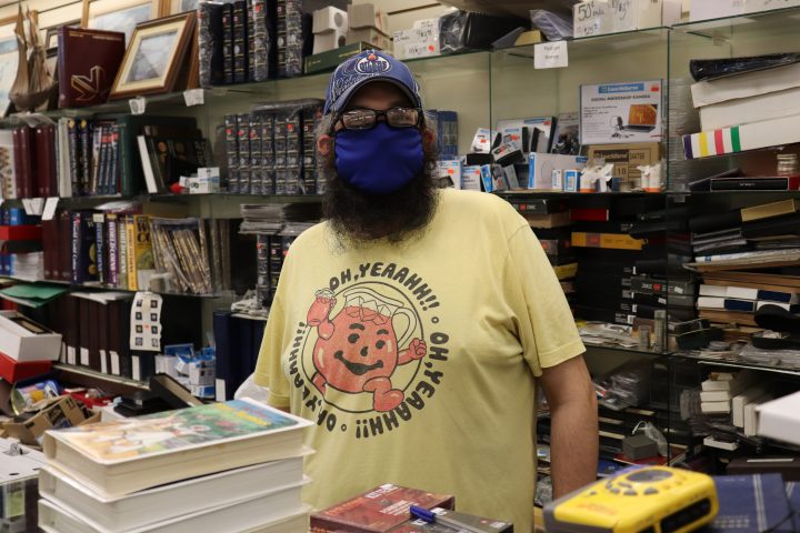 Bluenose Collectible employee, Reed Gilmore, behind the shop’s counter on Tuesday, July 21, 2020.