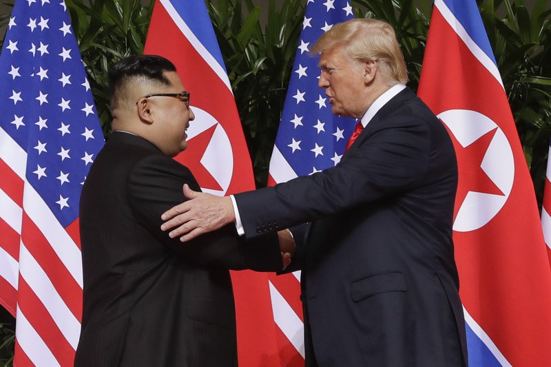 FILE - In this June 12, 2018, file photo, President Donald Trump, right, shakes hands with North Korea leader Kim Jong Un at the Capella resort on Sentosa Island in Singapore. North Korea on Tuesday, July 7, 2020, repeated it has no immediate intent to resume dialogue with the United States hours before U.S. Deputy Secretary of State Stephen Biegun was to arrive in South Korea for discussions on the stalled nuclear diplomacy. 