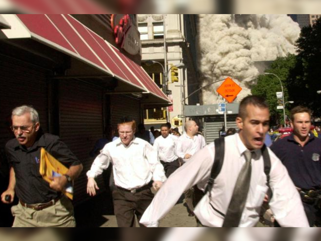 Stephen Cooper, who died of COVID-19, can be seen wearing a black shirt and glasses on the far left. He was delivering newspapers when the Twin Towers were hit on September 11, 2001.