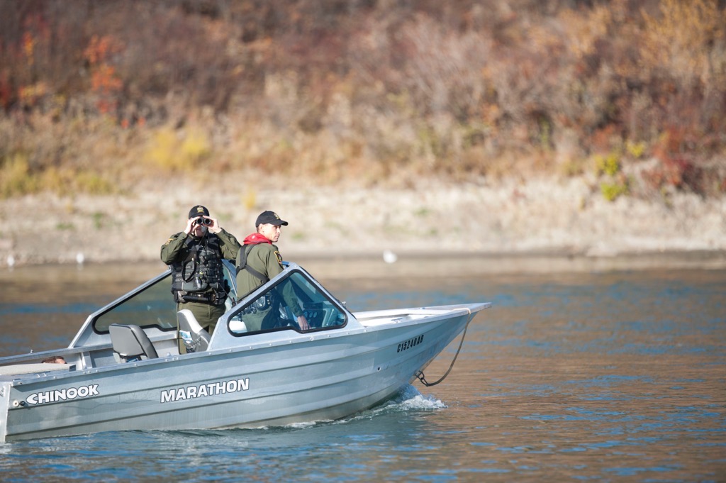 Alberta Fish and Wildlife officers patrol an Alberta waterway in July 2020.