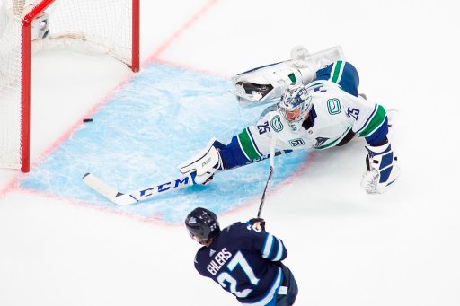 The Winnipeg Jets’ Nikolaj Ehlers (27) scores on Vancouver Canucks goaltender Jacob Markstrom (25) during second-period NHL exhibition game action in Edmonton, on Wednesday, July 29, 2020. THE CANADIAN PRESS/Codie McLachlan