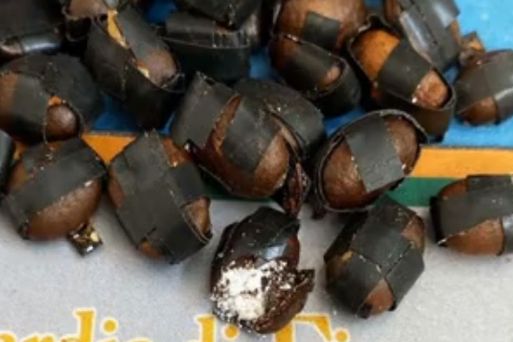 Coffee beans filled with cocaine are shown in this image released by police in Italy on July 17, 2020.