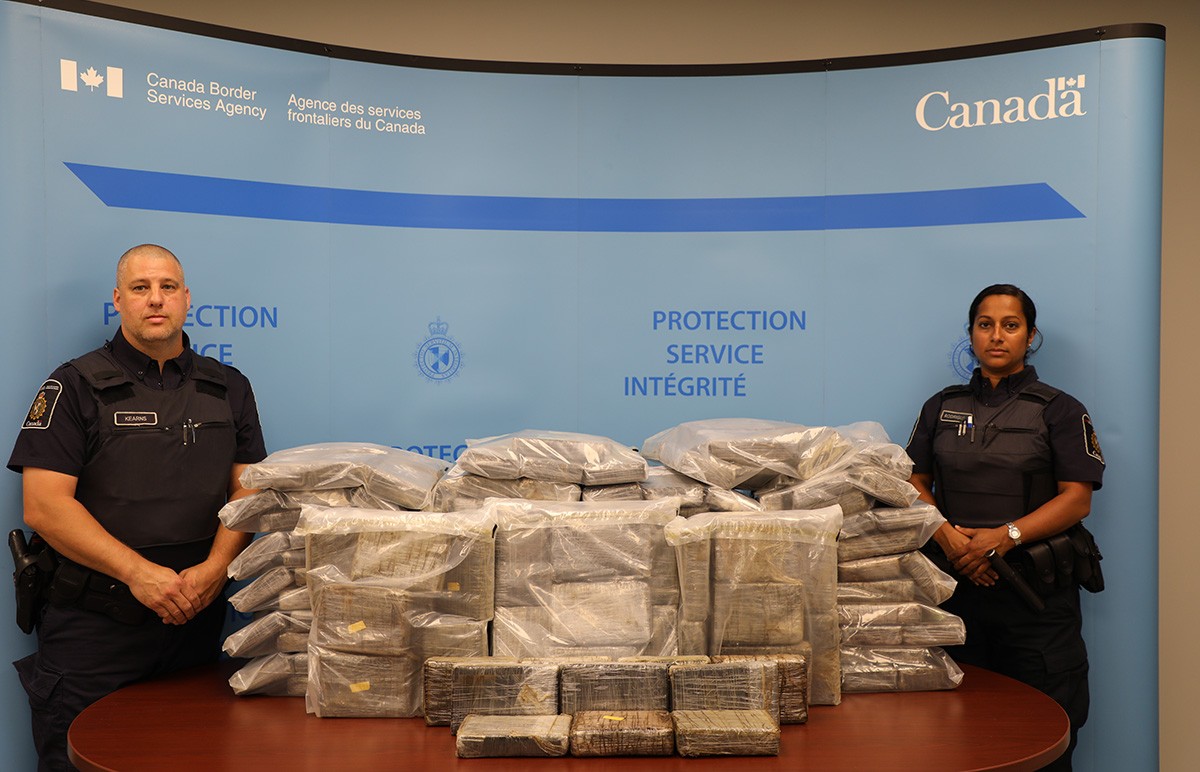 Officers from CBSA Halifax Marine Operations pictured with approximately 270 kg of suspected cocaine, seized from a vessel in Halifax, NS on July 18, 2020.