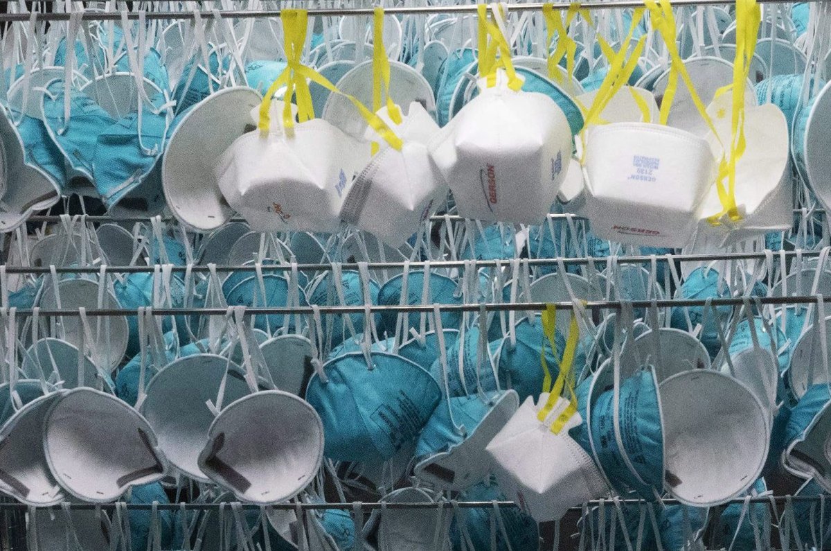 Protective masks hang in a decontamination unit at the Battelle N95 decontamination site during the coronavirus pandemic, Saturday, April 11, 2020, in Somerville, Mass. 