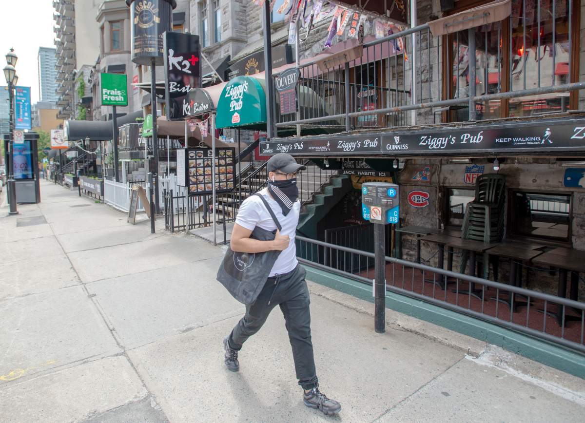 A man walks past closed bars and restaurants on Crescent Street Tuesday June 9, 2020 in Montreal. 