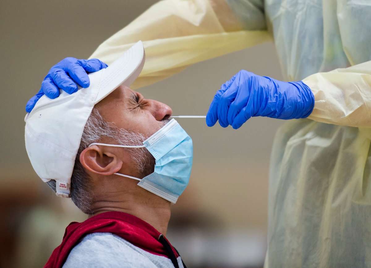 A man is tested for COVID-19 from a health-care worker at a pop-up testing centre at the Islamic Institute of Toronto during the COVID-19 pandemic in Scarborough, Ont., on Friday, May 29, 2020. 