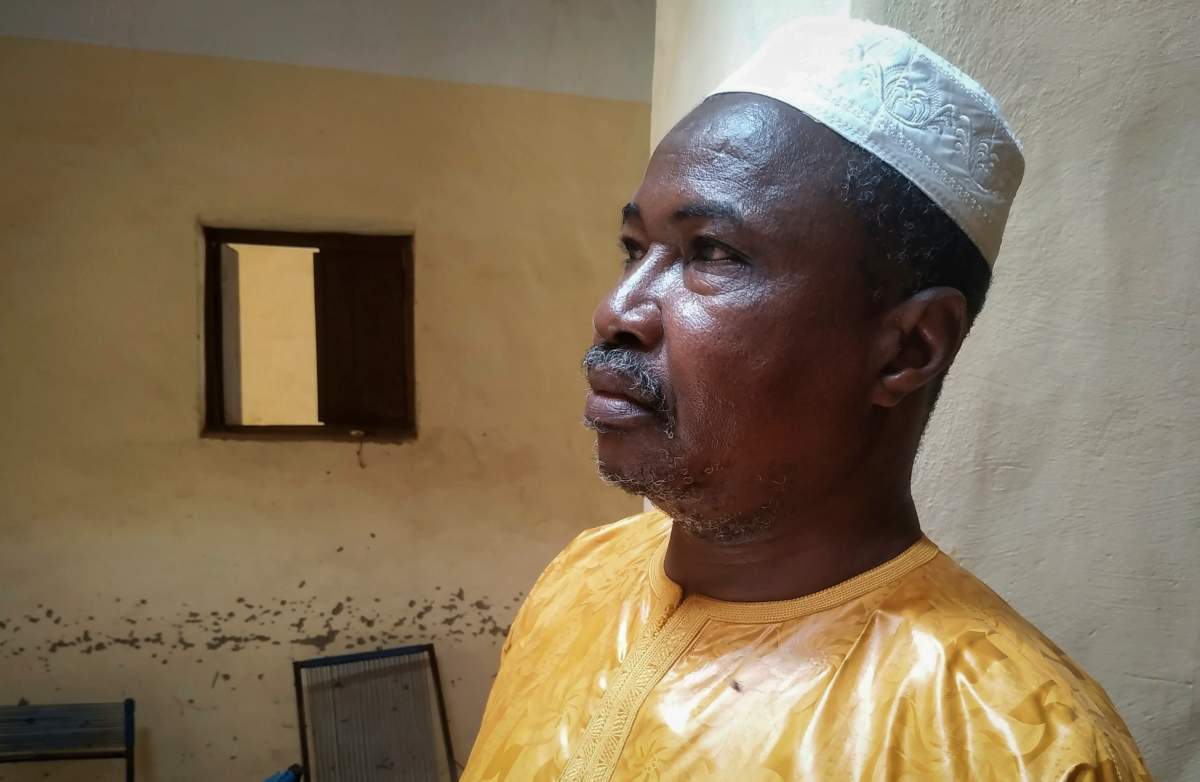 In this photo taken Friday, June 26, 2020, recovering coronavirus patient Harandane Toure, a teacher in his 50s, poses for a photo in his house in Timbuktu, Mali.