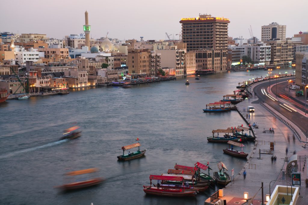 In this photograph taken with a slow shutter speed, traditional abra boats navigate the Dubai Creek in Dubai, United Arab Emirates, Wednesday, July 1, 2020. 