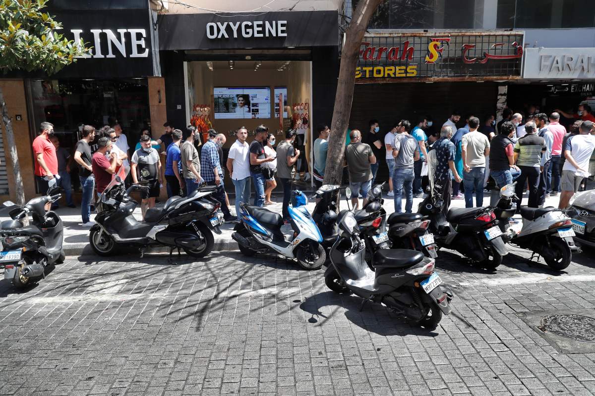 People line up outside an exchange shop to buy U.S. dollars, in Beirut, Lebanon, June 17, 2020.